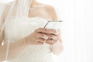 Bride is sending an email on mobile phone