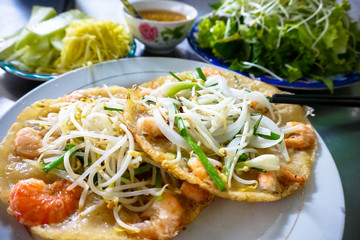 Vietnamese pancake banh xeo with shrimp, bean sprout, green onion and salad