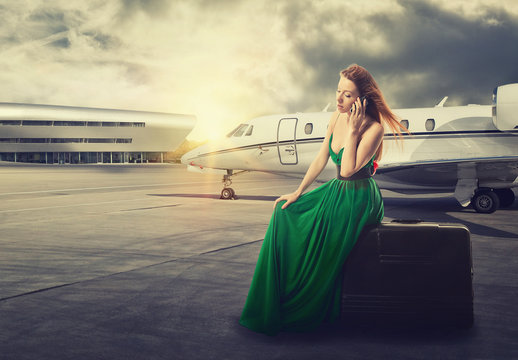 woman waiting flight departure talking on phone