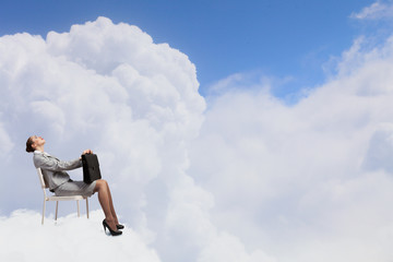 Businesswoman on cloud