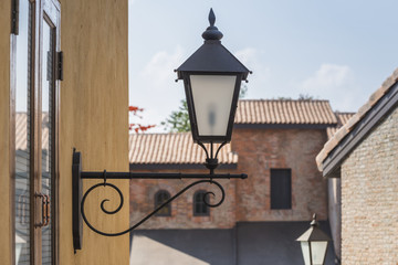 old lamp on the wall with vintage building background