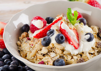 Healthy Breakfast with ripe fresh berries, yogurt and  muesli.