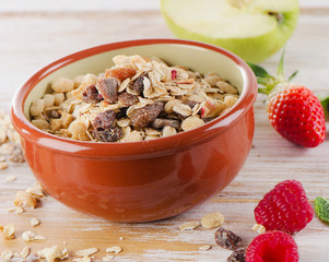 Muesli for breakfast with  berries and green apple .