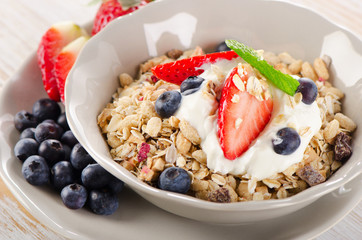 Healthy Breakfast with ripe berries, yogurt and  muesli.