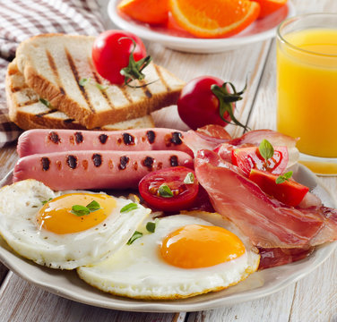 English Breakfast with  fried eggs, toasts, orange juice