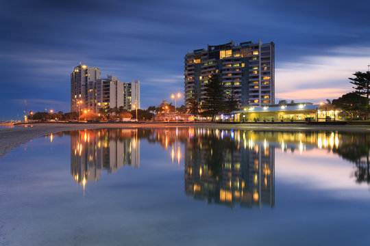 Australian suburb in front of water at night