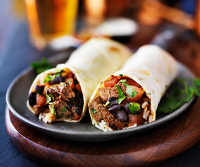 mexican beef burritos with beer in background - obrazy, fototapety, plakaty
