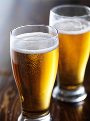 two mugs of beer close up