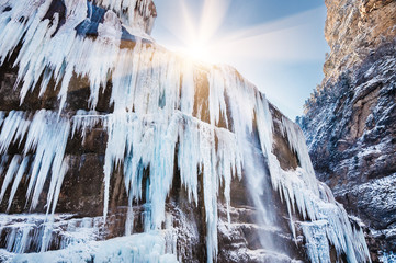 Icicles and a jet of water on the frozen waterfall