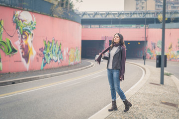 Beautiful young brunette posing in the city streets