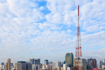 Naklejka premium many clouds cover the cityscape business building with antenna t