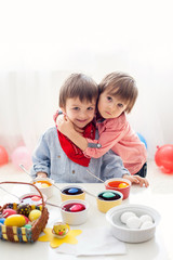 Two boys, coloring eggs for Easter