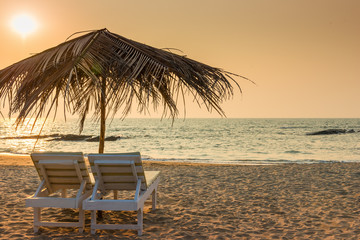 beautiful empty beach and a pair of sun loungers