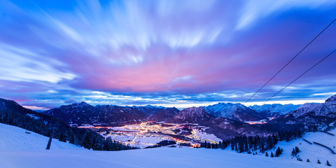 dynamic clouds over valley at winter night in tirol mountains - obrazy, fototapety, plakaty