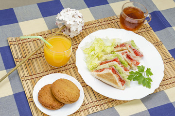 Huge breakfast with sandwich, orange juice, sweet and tea