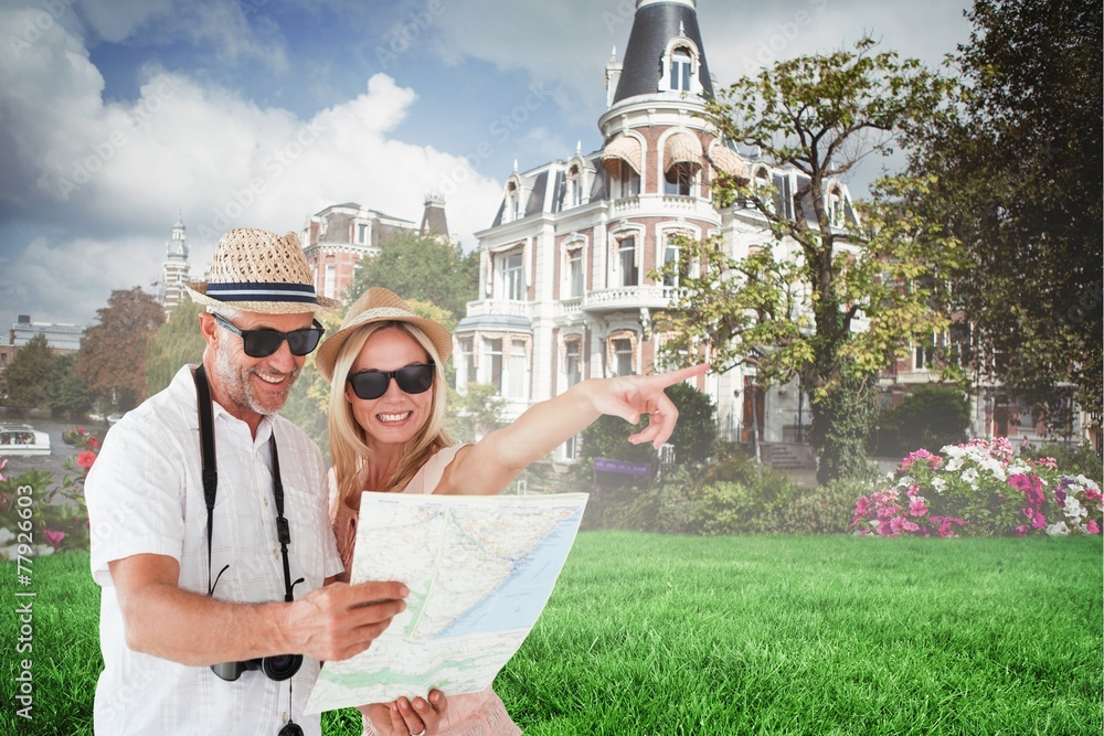 Aufkleber Composite image of happy tourist couple using map and pointing
