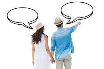 Happy hipster couple holding hands and looking