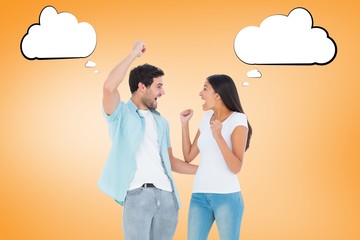 Composite image of happy casual couple cheering together