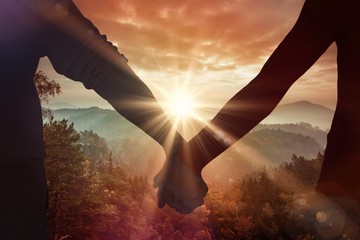 Composite image of couple holding hands rear view - Powered by Adobe