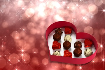 Composite image of heart shaped box of candy