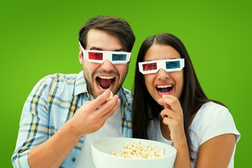 Obraz premium Composite image of attractive young couple watching a 3d movie