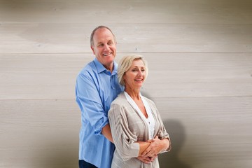 Composite image of happy mature couple embracing each other