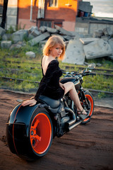 Fototapeta na wymiar red-haired girl on a motorcycle