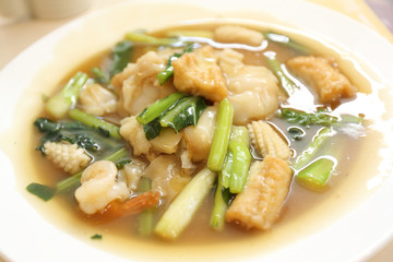 Thai food Wide Noodles in a Creamy Sauce with seafood