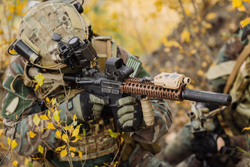 marines with a rifle aiming at a target