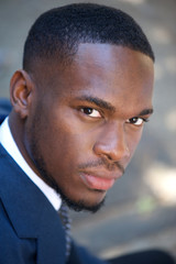 Fototapeta premium Young black businessman sitting outdoors