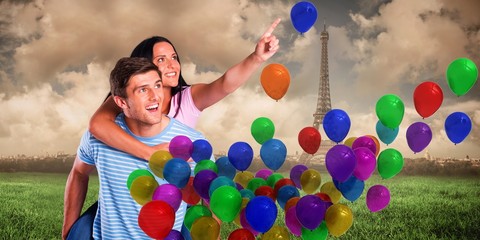 Composite image of young man giving girlfriend a piggyback ride