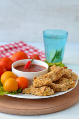 Chicken nuggets with tomato sauce