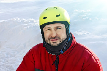 Young sporty man in a helmet in winter