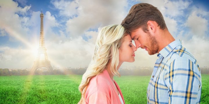 Composite image of attractive couple standing touching heads