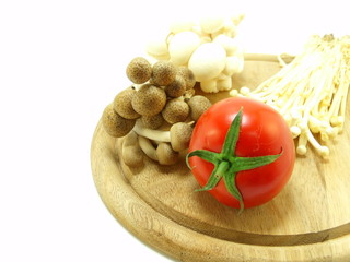 tomato and mushroom on wooden chopping board