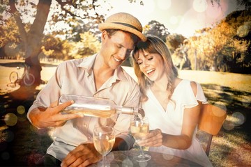 Cute couple drinking white wine together outside