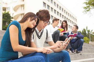 young couple student touching the smartphone