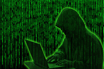 Conceptual image of a hacker on green matrix background