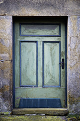 Old green door in a stone frame