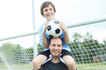 A young soccer player with ball on the field