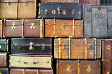 background with large stack of antique suitcases - 77946259