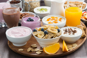 rich breakfast buffet with cereals, yoghurt and fruit