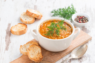 tomato soup with rice and vegetables in a white saucepan
