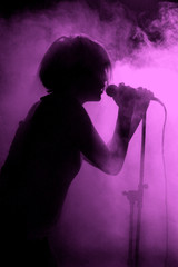 Female singer silhouette holding microphone
