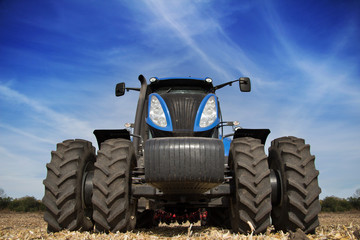 Tractor with big wheels in the field
