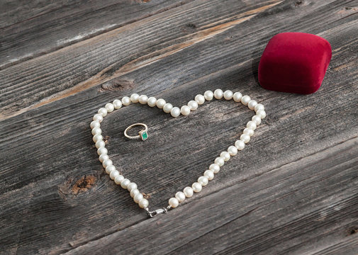 Engagement emerald ring and string of pearls. Valentine's day