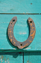 old rusty horseshoe luck symbol on farm wall