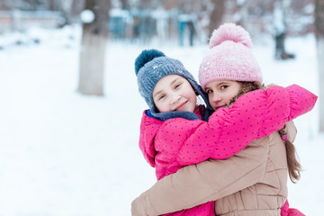 Fototapeta premium Happy girls playing on snow in winter