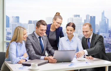 business team with laptop having discussion