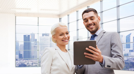 smiling businessmen with tablet pc outdoors